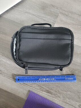 Black unbranded 3/4 zip lunch box with external pocket and hooks for strap